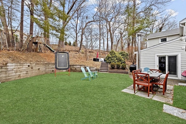 view of yard with a playground and a patio