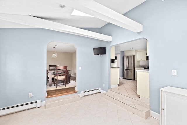 unfurnished room featuring a baseboard radiator, light tile patterned floors, and arched walkways