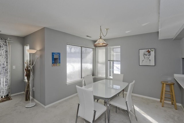 dining space with light carpet