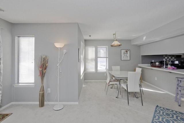 carpeted dining room featuring a healthy amount of sunlight