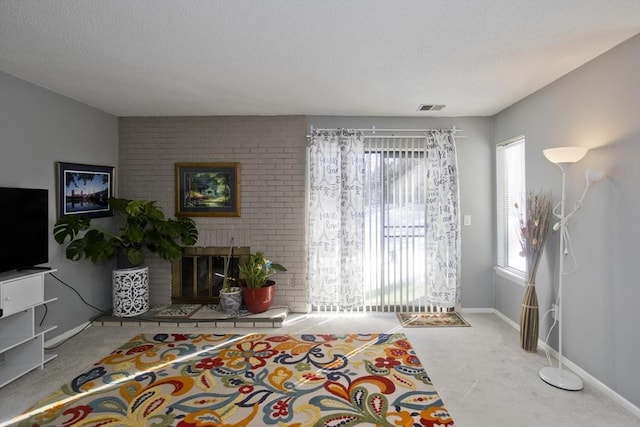 living room featuring carpet flooring and a fireplace