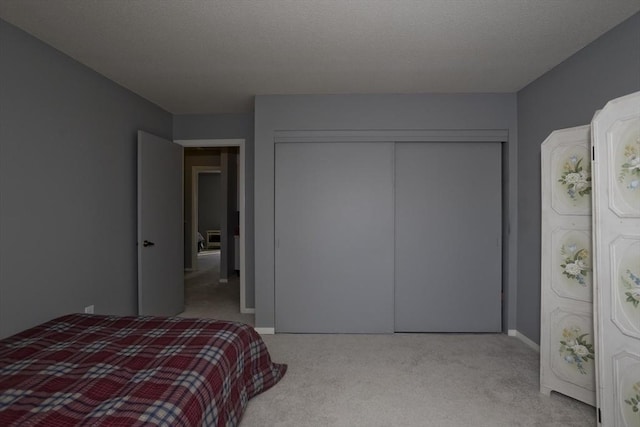 bedroom featuring light colored carpet and a closet