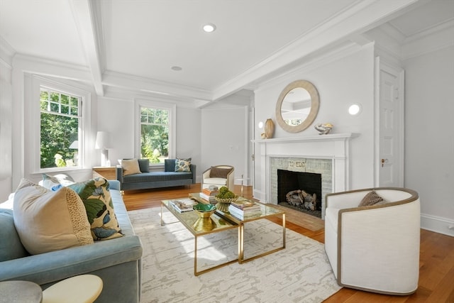 living room featuring ornamental molding, wood-type flooring, and beamed ceiling