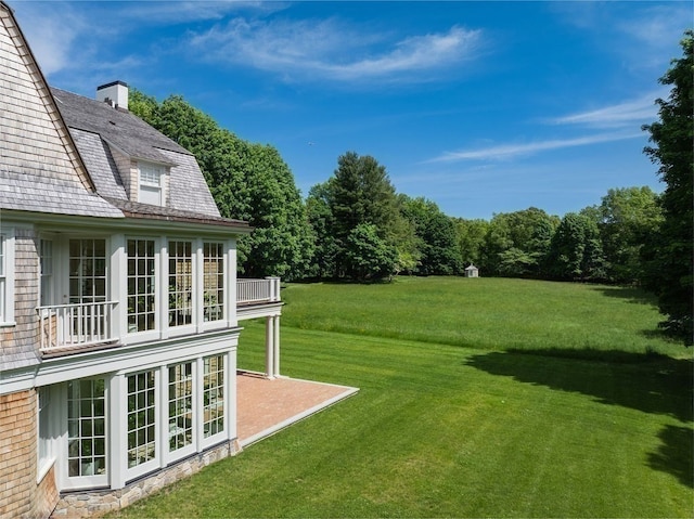 view of yard featuring a balcony