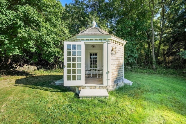 view of outdoor structure featuring a lawn