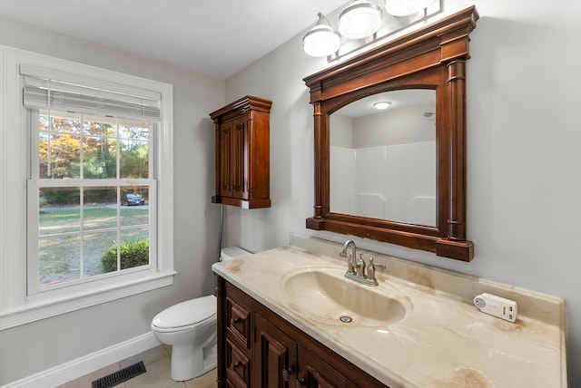 bathroom featuring vanity, toilet, and tile patterned flooring