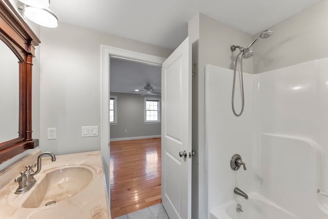 bathroom with vanity, shower / bathing tub combination, wood-type flooring, and ceiling fan