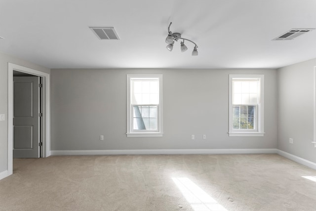 carpeted empty room with a wealth of natural light