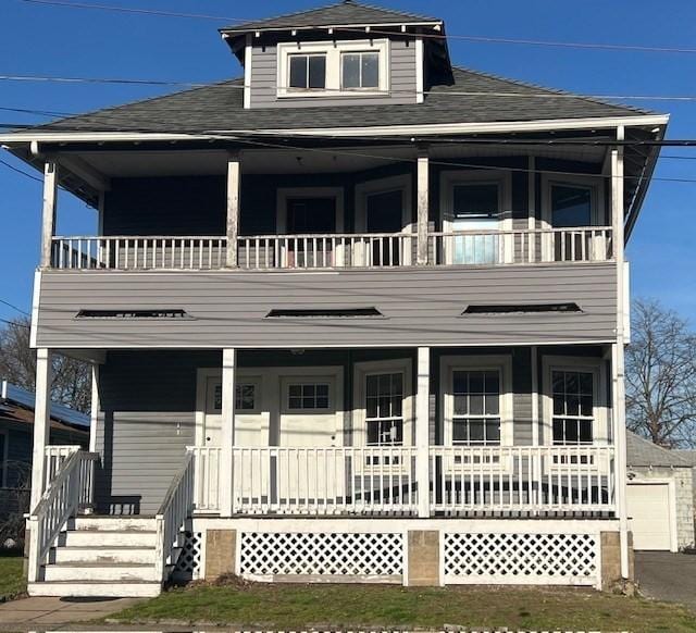 view of front of property with roof with shingles, covered porch, and a balcony