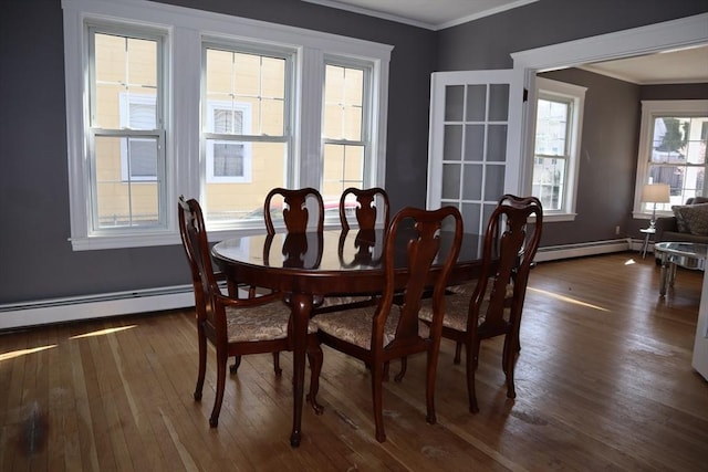 dining room featuring ornamental molding, baseboards, a baseboard radiator, and dark wood finished floors