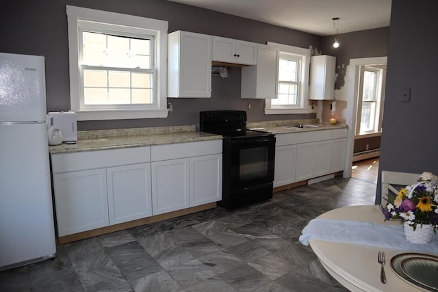 kitchen featuring black / electric stove, pendant lighting, white cabinets, freestanding refrigerator, and a baseboard radiator