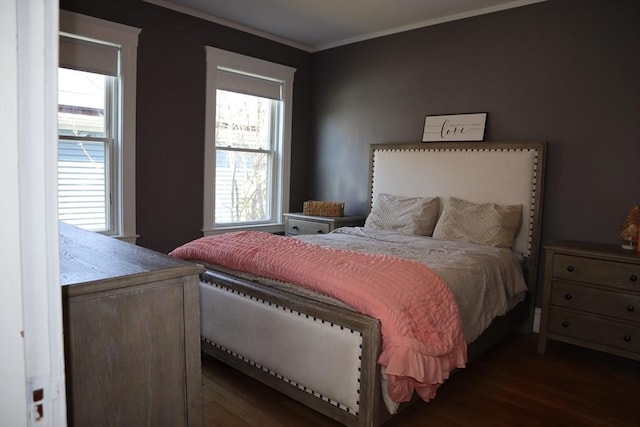bedroom featuring wood finished floors and crown molding