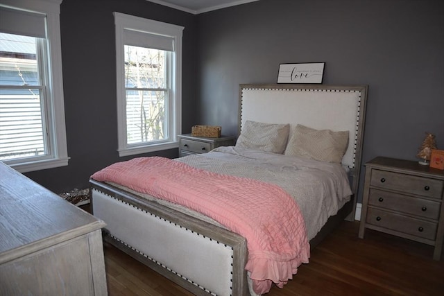 bedroom with ornamental molding, dark wood-style floors, and multiple windows