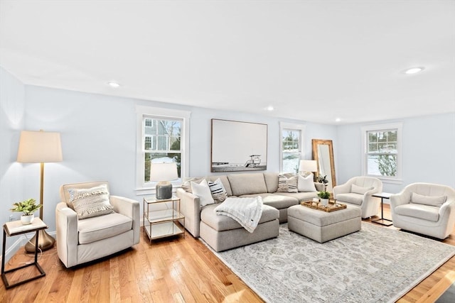 living room featuring light wood-type flooring and recessed lighting