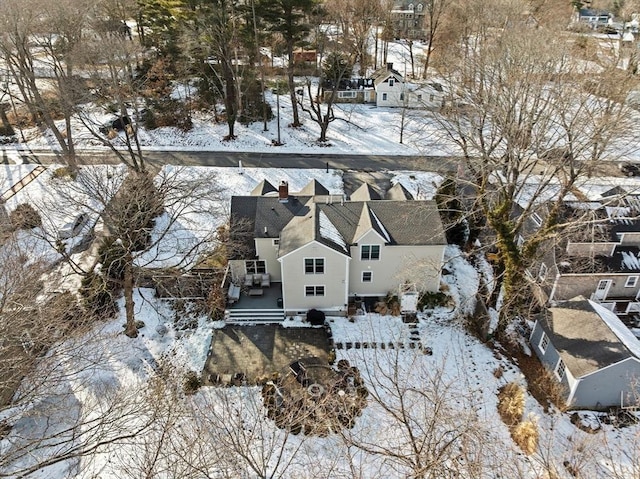 snowy aerial view with a residential view