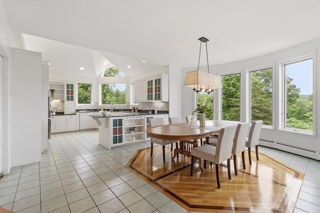 52 S Nelson Rd, Sterling, MA 01564 - dining area with light tile patterned floors, healthy amount of natural light, baseboard heating, vaulted ceiling, and a chandelier