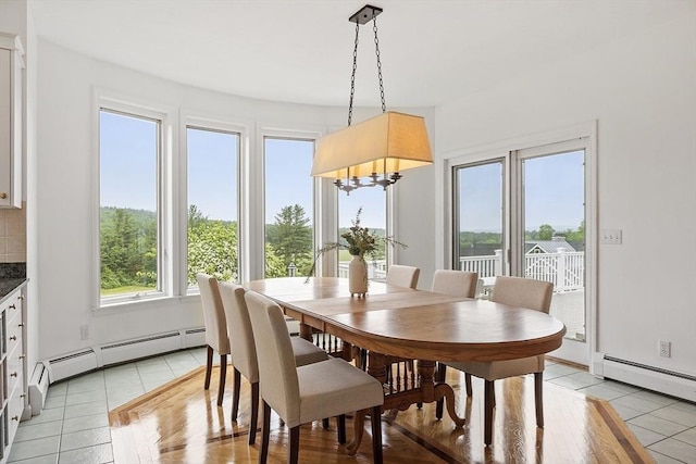 52 S Nelson Rd, Sterling, MA 01564 - dining space with light tile patterned floors, a baseboard heating unit, and a chandelier