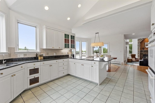 52 S Nelson Rd, Sterling, MA 01564 - kitchen with a peninsula, decorative backsplash, vaulted ceiling, healthy amount of natural light, and recessed lighting