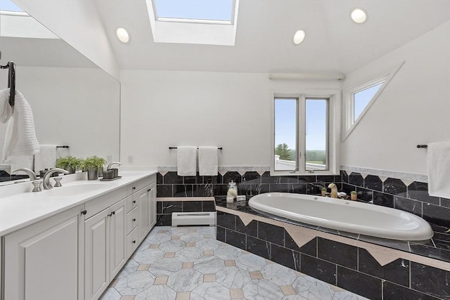 52 S Nelson Rd, Sterling, MA 01564 - full bathroom with a baseboard heating unit, double vanity, a bath, a skylight, and recessed lighting