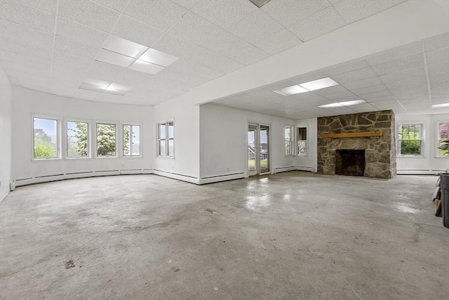 52 S Nelson Rd, Sterling, MA 01564 - unfurnished living room with a drop ceiling, unfinished concrete floors, a baseboard heating unit, and plenty of natural light