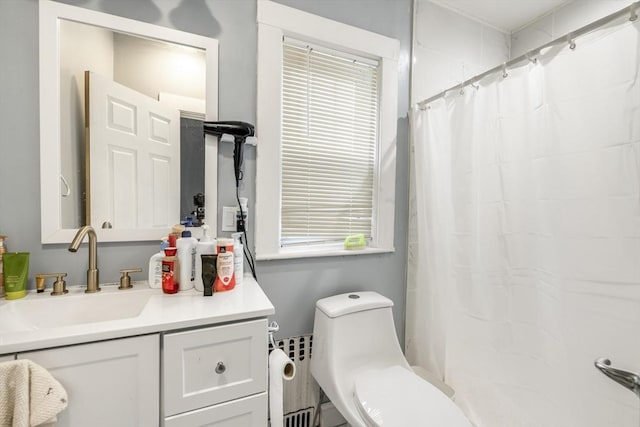 bathroom with a shower with curtain, vanity, radiator heating unit, and toilet