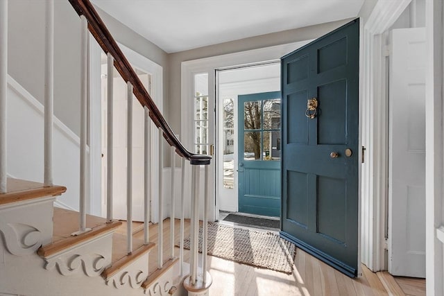 foyer featuring stairway and light wood finished floors