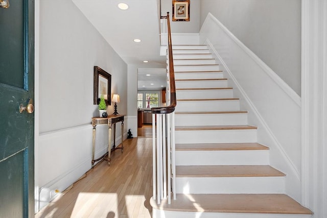 stairs with recessed lighting and wood finished floors