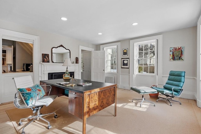 office space with radiator heating unit, a fireplace, and recessed lighting