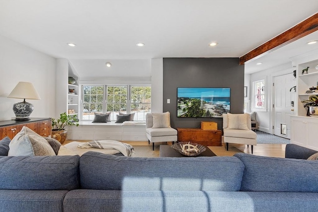 living area featuring beamed ceiling, built in features, and recessed lighting