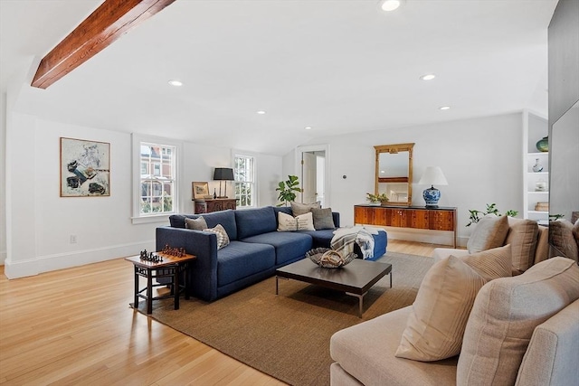 living area featuring light wood-style floors, recessed lighting, vaulted ceiling with beams, and baseboards