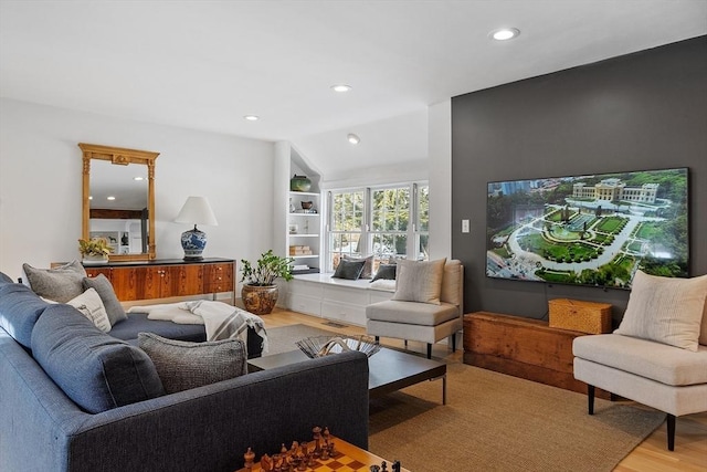 living room with light wood-type flooring, vaulted ceiling, and recessed lighting