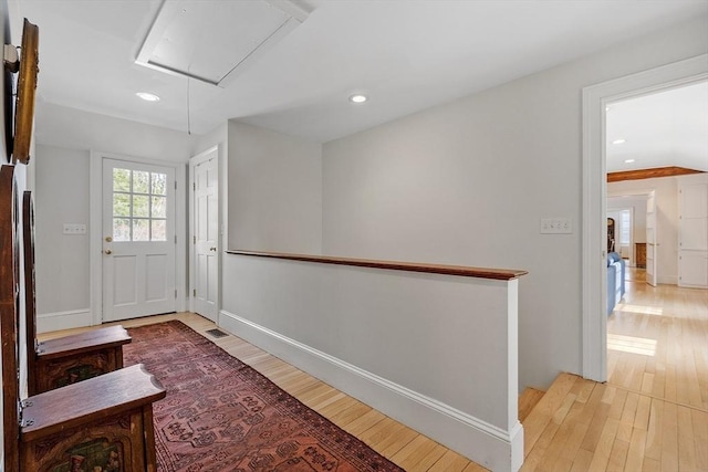 doorway to outside with light wood-style floors, recessed lighting, visible vents, and baseboards