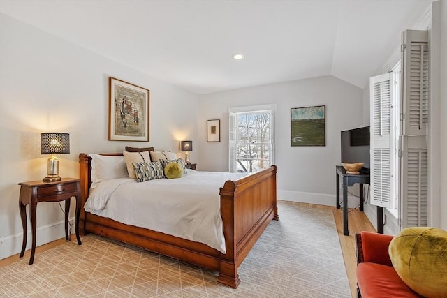 bedroom with lofted ceiling, baseboards, and recessed lighting