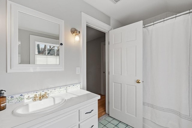 bathroom featuring curtained shower, tile patterned flooring, and vanity