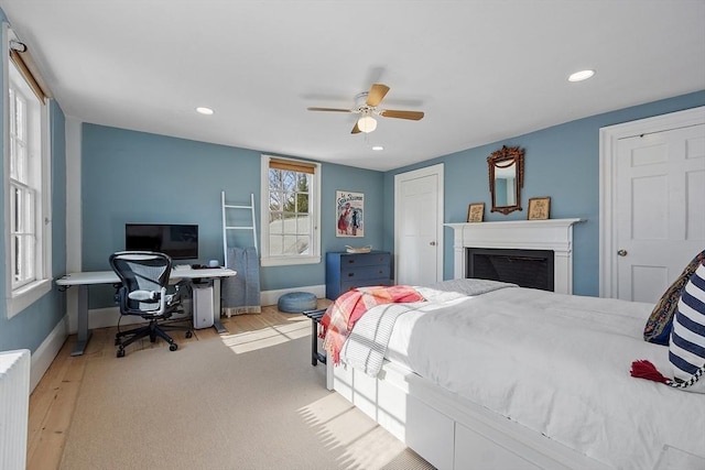 bedroom with ceiling fan, recessed lighting, a fireplace, and baseboards