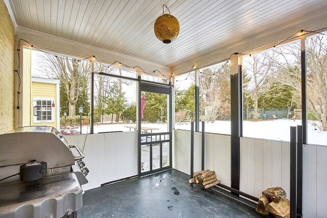 sunroom / solarium featuring wood ceiling and plenty of natural light