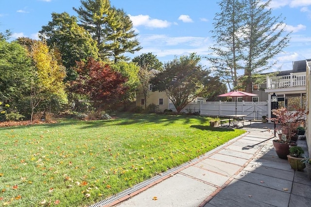 view of yard featuring fence and a patio