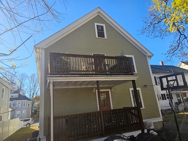 back of property featuring a balcony