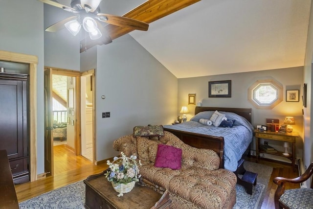 bedroom with ceiling fan, vaulted ceiling, and light wood-style flooring
