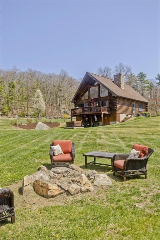 view of property's community featuring a lawn and a deck