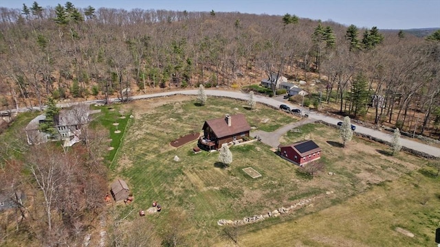 birds eye view of property featuring a wooded view