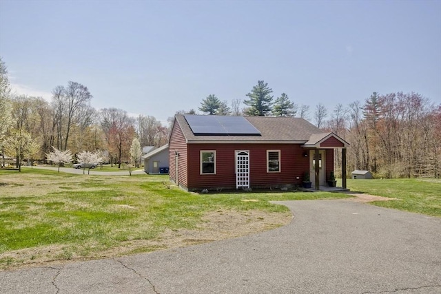 view of outbuilding featuring solar panels