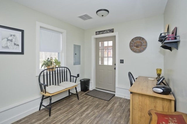 entryway featuring visible vents, baseboards, wood finished floors, and electric panel