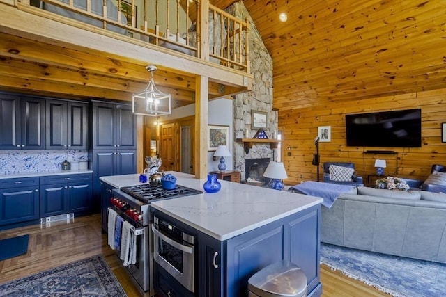 kitchen featuring a center island, a fireplace, high vaulted ceiling, open floor plan, and stainless steel appliances