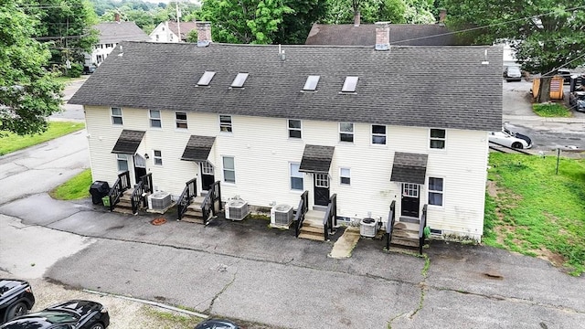 6 A St Unit 6, Northbridge, MA 01588 - rear view of house with entry steps, a shingled roof, and a chimney