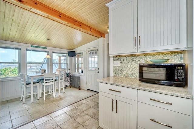 32 Hale Ave, Winthrop, MA 02152 - kitchen featuring black microwave, plenty of natural light, wooden ceiling, white cabinets, and light tile patterned floors