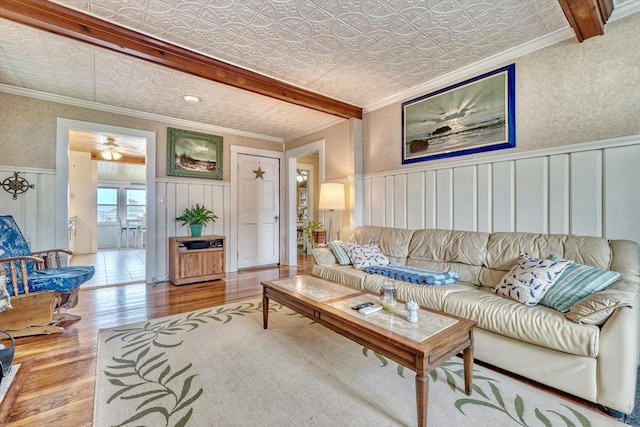 32 Hale Ave, Winthrop, MA 02152 - living area featuring wood finished floors, an ornate ceiling, crown molding, a wainscoted wall, and a ceiling fan