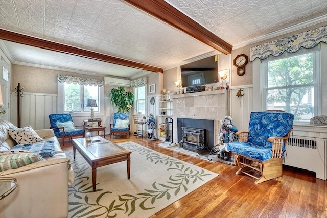 32 Hale Ave, Winthrop, MA 02152 - living room featuring wood finished floors, crown molding, an ornate ceiling, an AC wall unit, and radiator heating unit