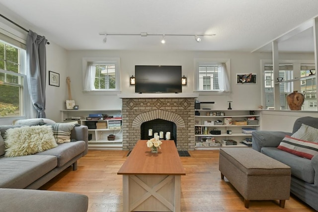 11 Goodway Rd Unit 1, Boston, MA 02130 - living room featuring wood finished floors, a brick fireplace, and track lighting