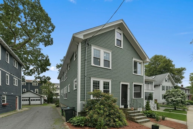 11 Goodway Rd Unit 1, Boston, MA 02130 - view of front of property featuring an outdoor structure, a detached garage, and a residential view